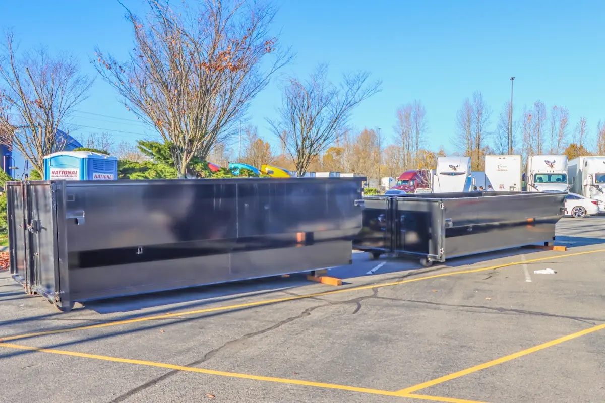 Professional dumpster rental service with roll-off container on residential driveway in Fort Bragg